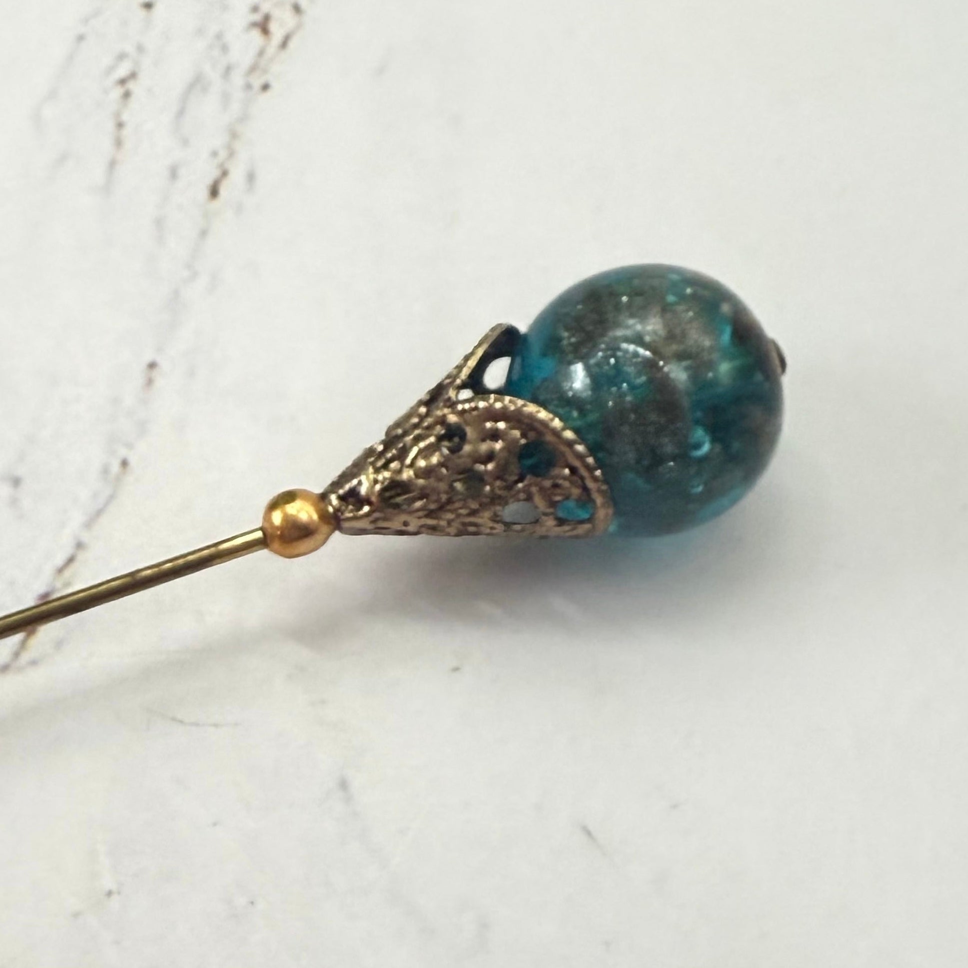 ✨ Handmade Vintage-Inspired Hatpin | Stick Pin | Hat Accessory | Sweater & Hijab Pin | Decorative Jewelry Gift for Her ✨

Vintage-Style Aqua Blue Glass Embedded Metallic Flecks Filigree Cone Base Hatpin - 6 inch