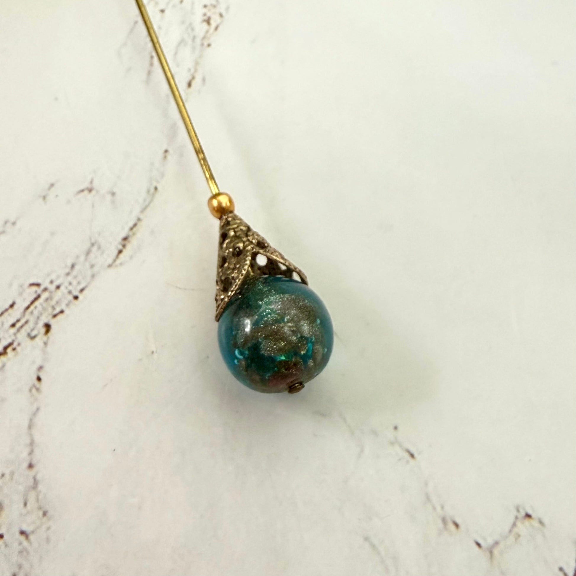 ✨ Handmade Vintage-Inspired Hatpin | Stick Pin | Hat Accessory | Sweater & Hijab Pin | Decorative Jewelry Gift for Her ✨

Vintage-Style Aqua Blue Glass Embedded Metallic Flecks Filigree Cone Base Hatpin - 6 inch