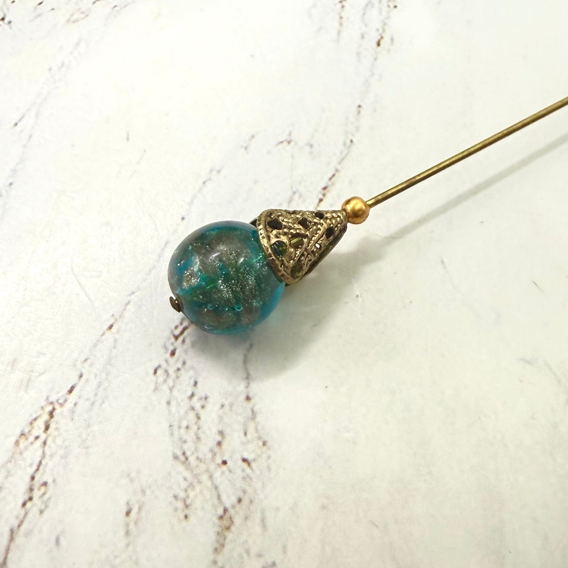 ✨ Handmade Vintage-Inspired Hatpin | Stick Pin | Hat Accessory | Sweater & Hijab Pin | Decorative Jewelry Gift for Her ✨

Vintage-Style Aqua Blue Glass Embedded Metallic Flecks Filigree Cone Base Hatpin - 6 inch