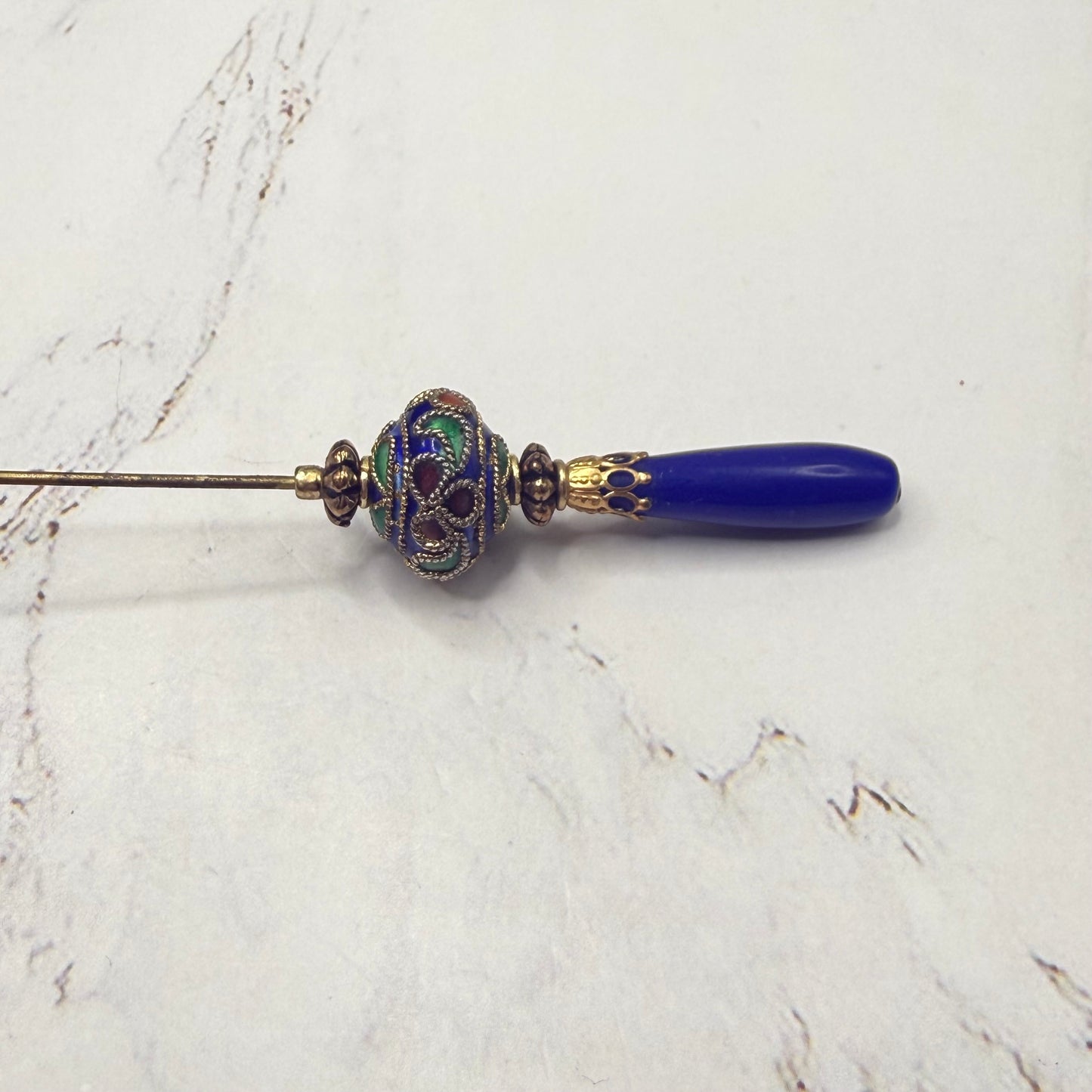 ✨Handmade Vintage Inspired Hatpin, Stick Pin, Gifts for Her, Hat Accessory, Jewelry Decor✨

Blue Glass Tapered Final Multi Color Floral Design Cloisonné Gold Tone Filigree Accent Hatpin - 6 Inch