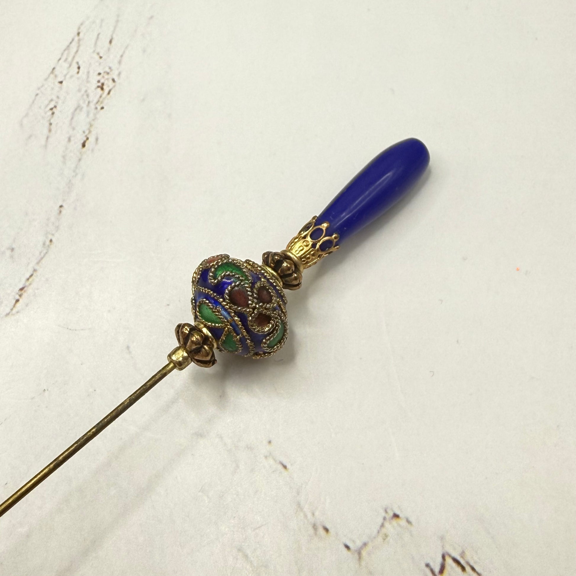 ✨Handmade Vintage Inspired Hatpin, Stick Pin, Gifts for Her, Hat Accessory, Jewelry Decor✨

Blue Glass Tapered Final Multi Color Floral Design Cloisonné Gold Tone Filigree Accent Hatpin - 6 Inch