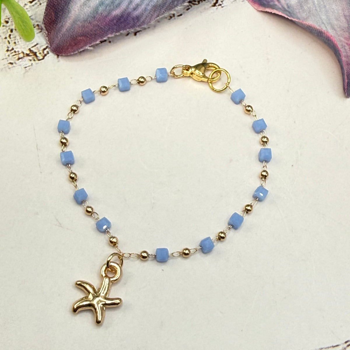 ✨Handmade Doll Jewelry Designed to Fit popular 18 Inch Fashion Dolls: add a little “Summer Fun ☀️ Beachy Style 🏝️” to your favorite doll!✨

Blue Square Round Gold Beaded Chain Gold Starfish Charm Doll Necklace
