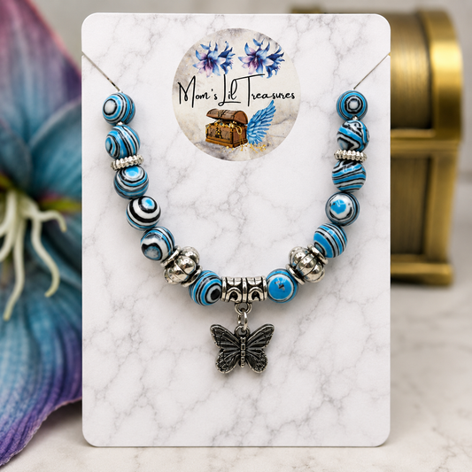 ✨Handmade Jewelry Designed to fit popular 17 to 20 cm (6 to 7 inch) Plushie Labubu Monster Dolls: add a stylish touch to your favorite plushie! ✨

Blue White Black Swirl Glass Beaded Silver Butterfly Charm Necklace