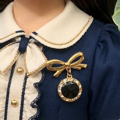 Gold Tone Bow Pin Black & Clear Rhinestone Dangle Doll Brooch