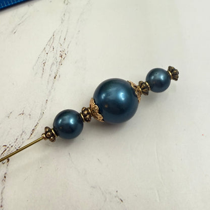 ✨ Handmade Vintage-Inspired Hatpin | Stick Pin | Hat Accessory | Sweater & Hijab Pin | Decorative Jewelry Gift for Her ✨

Dark Petrol Blue Faux Pearl Stacked Beads with Gold Tone Filigree Bead Accents Hatpin - 6 Inch