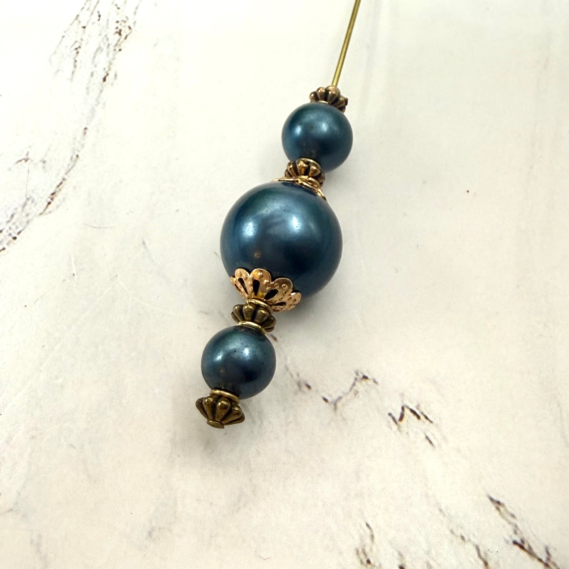 ✨ Handmade Vintage-Inspired Hatpin | Stick Pin | Hat Accessory | Sweater & Hijab Pin | Decorative Jewelry Gift for Her ✨

Dark Petrol Blue Faux Pearl Stacked Beads with Gold Tone Filigree Bead Accents Hatpin - 6 Inch