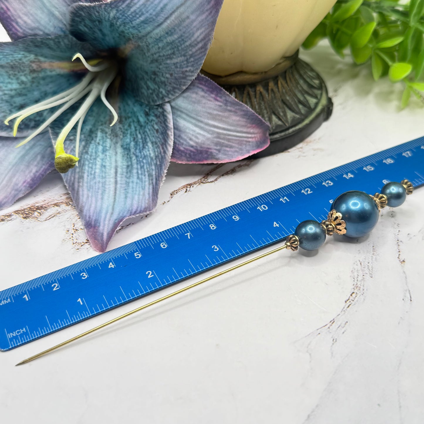 ✨ Handmade Vintage-Inspired Hatpin | Stick Pin | Hat Accessory | Sweater & Hijab Pin | Decorative Jewelry Gift for Her ✨

Dark Petrol Blue Faux Pearl Stacked Beads with Gold Tone Filigree Bead Accents Hatpin - 6 Inch