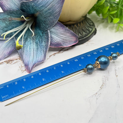 ✨ Handmade Vintage-Inspired Hatpin | Stick Pin | Hat Accessory | Sweater & Hijab Pin | Decorative Jewelry Gift for Her ✨

Dark Petrol Blue Faux Pearl Stacked Beads with Gold Tone Filigree Bead Accents Hatpin - 6 Inch