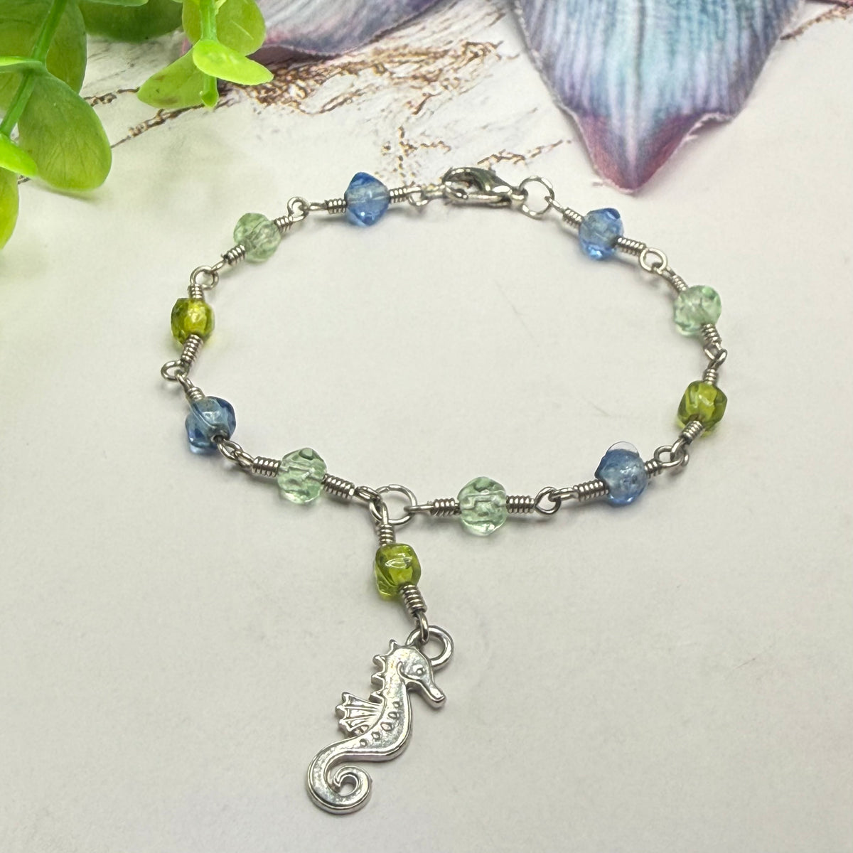 ✨Handmade Doll Jewelry Designed to Fit popular 18 Inch Fashion Dolls: add a little “Summer Fun ☀️ Beachy Style 🏝️” to your favorite doll!✨

Green Blue Glass Beaded Silver Link Chain Seahorse Charm Doll Necklace