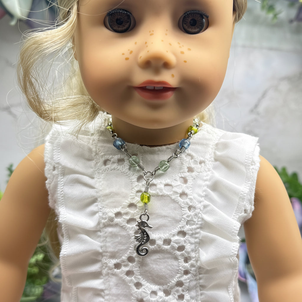 ✨Handmade Doll Jewelry Designed to Fit popular 18 Inch Fashion Dolls: add a little “Summer Fun ☀️ Beachy Style 🏝️” to your favorite doll!✨

Green Blue Glass Beaded Silver Link Chain Seahorse Charm Doll Necklace