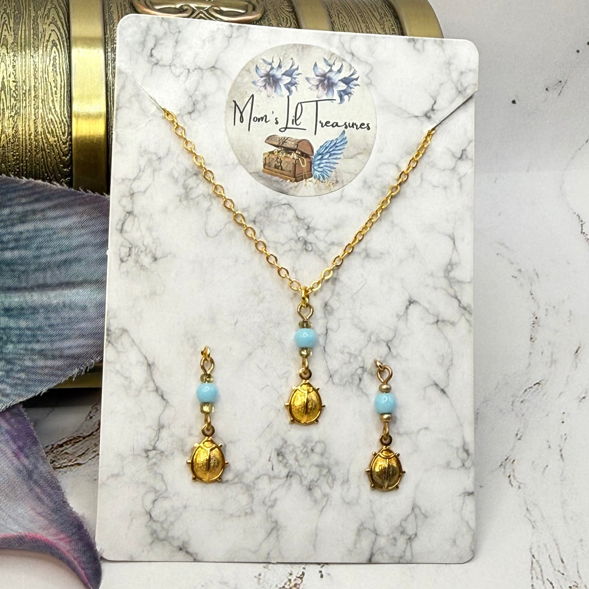 ✨ Handmade Doll Jewelry Designed to Fit popular 18 Inch Fashion Dolls: add a stylish touch to your favorite doll ✨

Light Blue Glass Gold Lady Bug Charm Doll Necklace & Matching Earrings Set