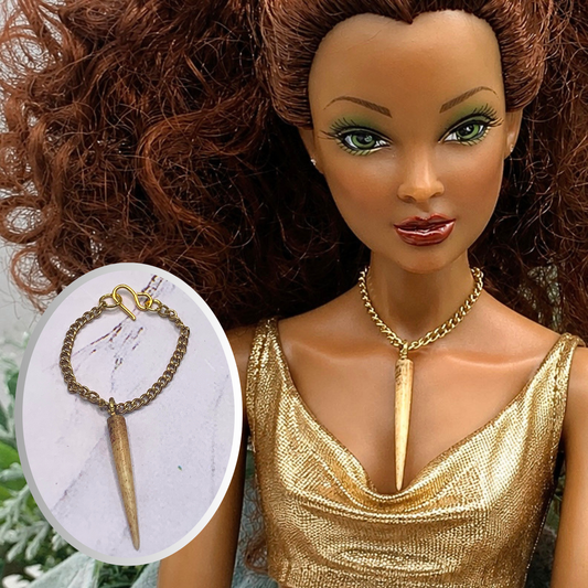 Long Spear Shaped Statement Pendant Doll Necklace. Necklace measures 2.75 inches long. Necklace and shown on 16” Spellbound Valentiana doll