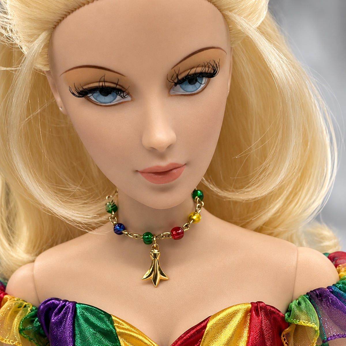Dress up your favorite doll with this Multi Color Glass Bead Gold Charm Doll Necklace. This necklace is 2-3/4 inches in length. Necklace shown on 16” Madame Alexander - Alex doll