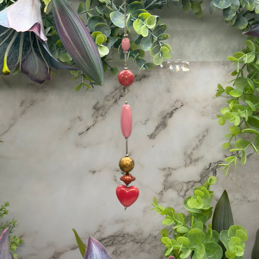 Pink Heart Dangle - Bronze & Pink Beaded Chain Car Mirror / Sun Catcher. The dangle section is 5 inches and the chain (that hooks around mirror) is 4.25 inches long. Total length is 9.25 inches long. Has hook closure to easily adjust length for your car.