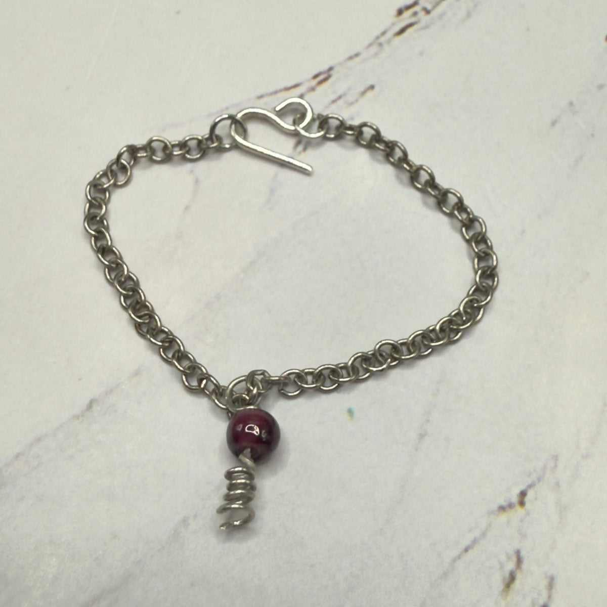 Red Drop Silver Spiral Pendant Doll Necklace. Necklace chain measures 3 7/8 inches long. Necklace shown on 16” Spellbound Valentina doll