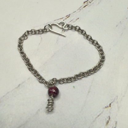 Red Drop Silver Spiral Pendant Doll Necklace. Necklace chain measures 3 7/8 inches long. Necklace shown on 16” Spellbound Valentina doll