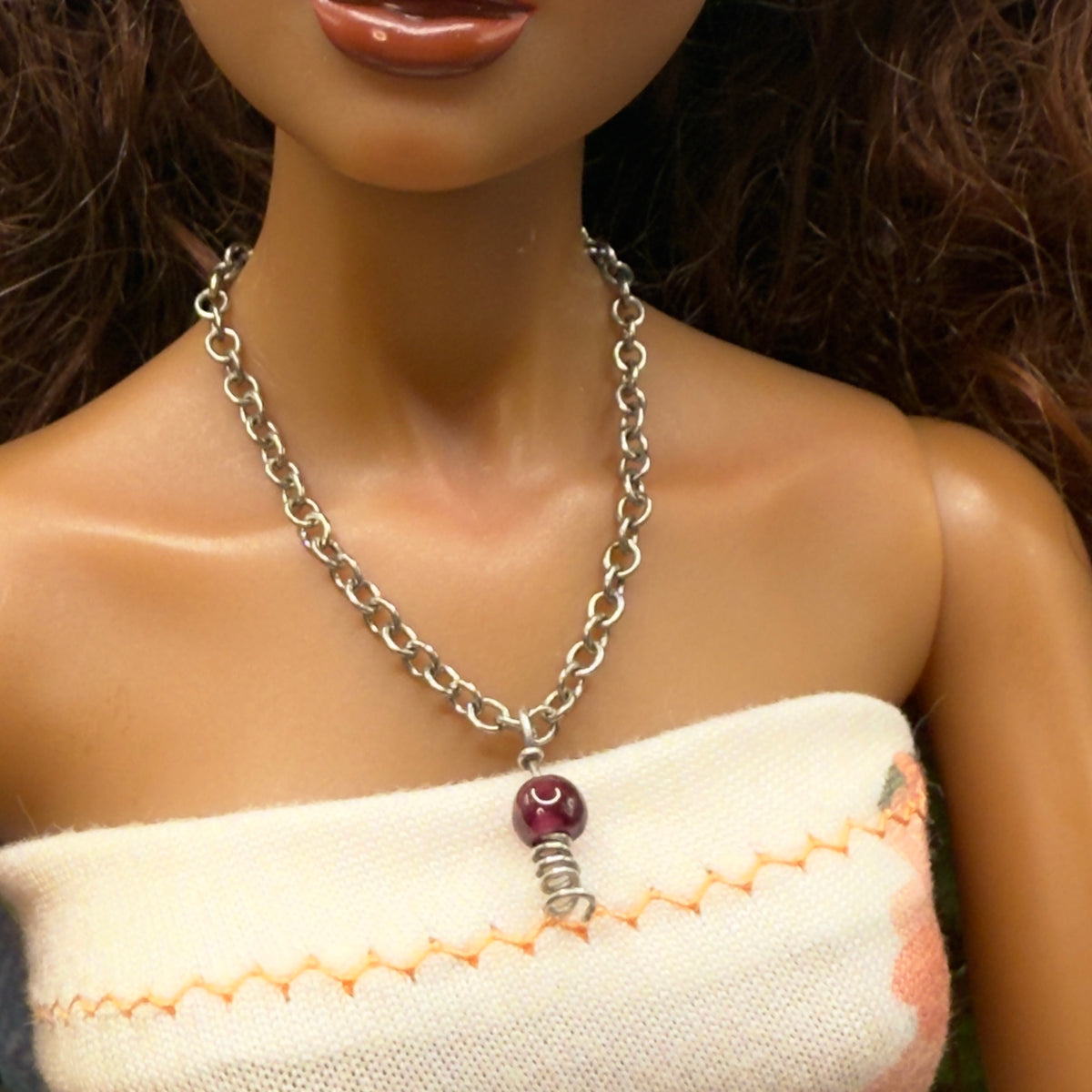 Red Drop Silver Spiral Pendant Doll Necklace. Necklace chain measures 3 7/8 inches long. Necklace shown on 16” Spellbound Valentina doll