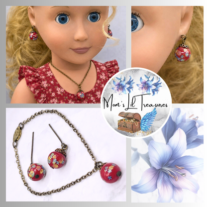 Add a pop of color to your doll's outfit with this Red glass Drop Pendant Doll Necklace Earrings Set. The set includes a red pendant necklace and matching earrings with floral design. The necklace measures 6.5 in length. Necklace and earrings shown on 18" Our Generation doll