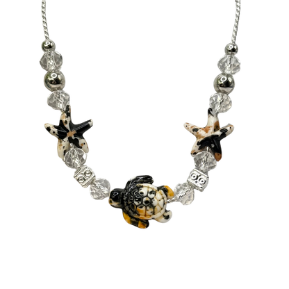 ✨Handmade Doll Jewelry Designed to Fit popular 18 Inch Fashion Dolls: add a little “Summer Fun ☀️ Beachy Style 🏝️” to your favorite doll!✨

Black Yellow Starfish Sea Turtle Charm Clear Crystal Beaded Doll Necklace