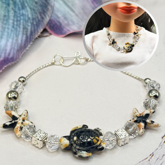 ✨Handmade Doll Jewelry Designed to Fit popular 18 Inch Fashion Dolls: add a little “Summer Fun ☀️ Beachy Style 🏝️” to your favorite doll!✨
Black Yellow Starfish Sea Turtle Charm Clear Crystal Beaded Doll Necklace