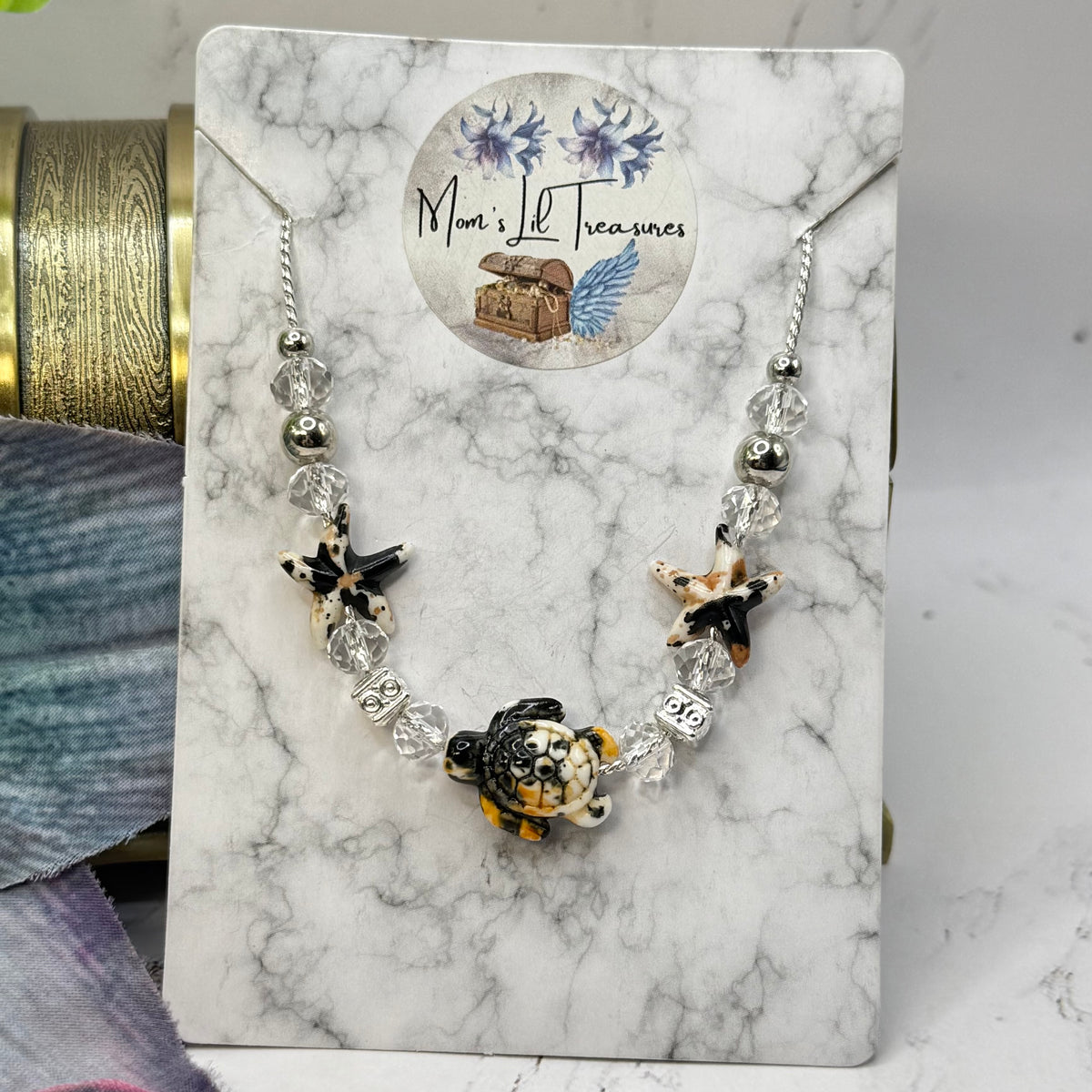 ✨Handmade Doll Jewelry Designed to Fit popular 18 Inch Fashion Dolls: add a little “Summer Fun ☀️ Beachy Style 🏝️” to your favorite doll!✨

Black Yellow Starfish Sea Turtle Charm Clear Crystal Beaded Doll Necklace