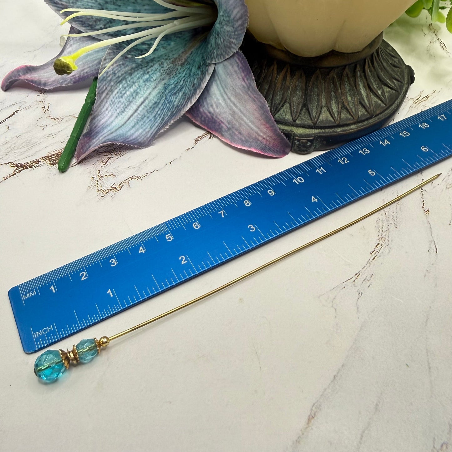 ✨ Handmade Vintage-Inspired Hatpin | Stick Pin | Hat Accessory | Shawl - Scarf  - Hijab Pin | Decorative Jewelry Gift for Her ✨

Translucent Aqua-Blue Facted Glass Crystal and Gold Tone Accents Hatpin - 6 inch