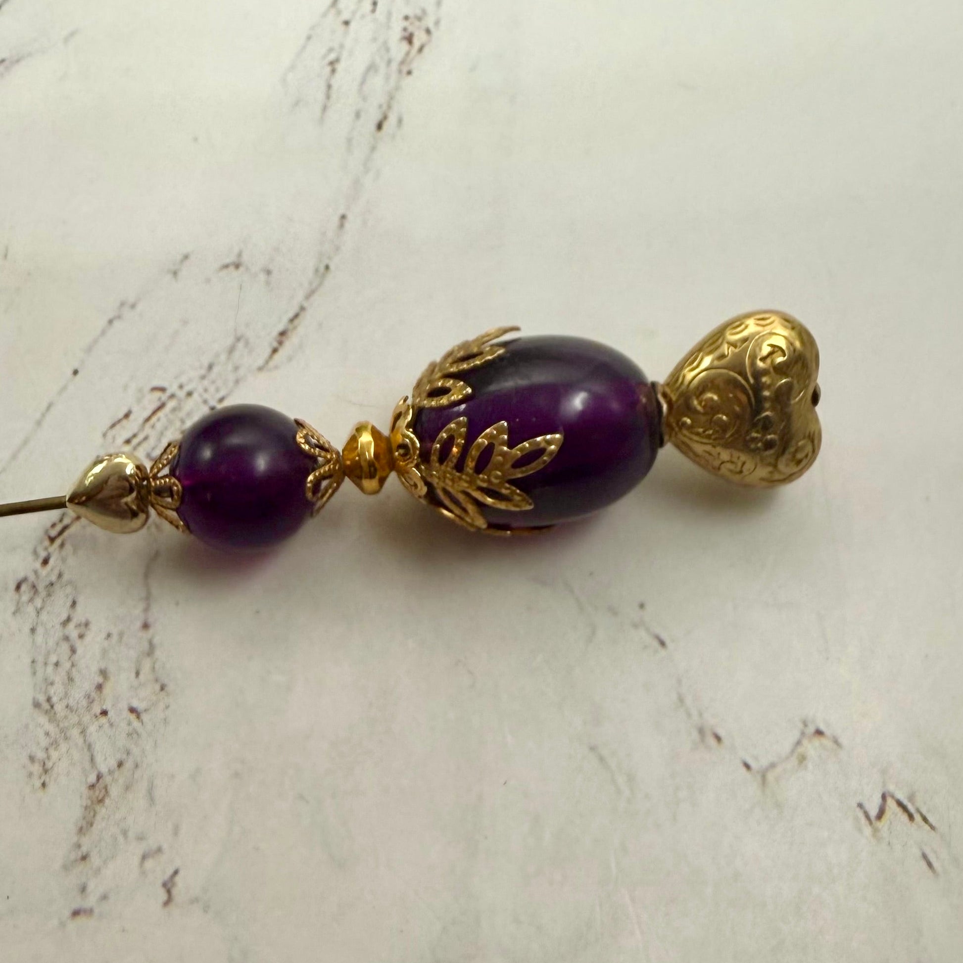 ✨ Handmade Vintage-Inspired Hatpin | Stick Pin | Hat Accessory | Sweater & Hijab Pin | Decorative Jewelry Gift for Her ✨

Deep Purple Class Gold Tone Heart-Shaped Top Finial and Filigree Hatpin • 6 Inch